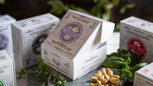 Food and beverage product boxes on a stone table