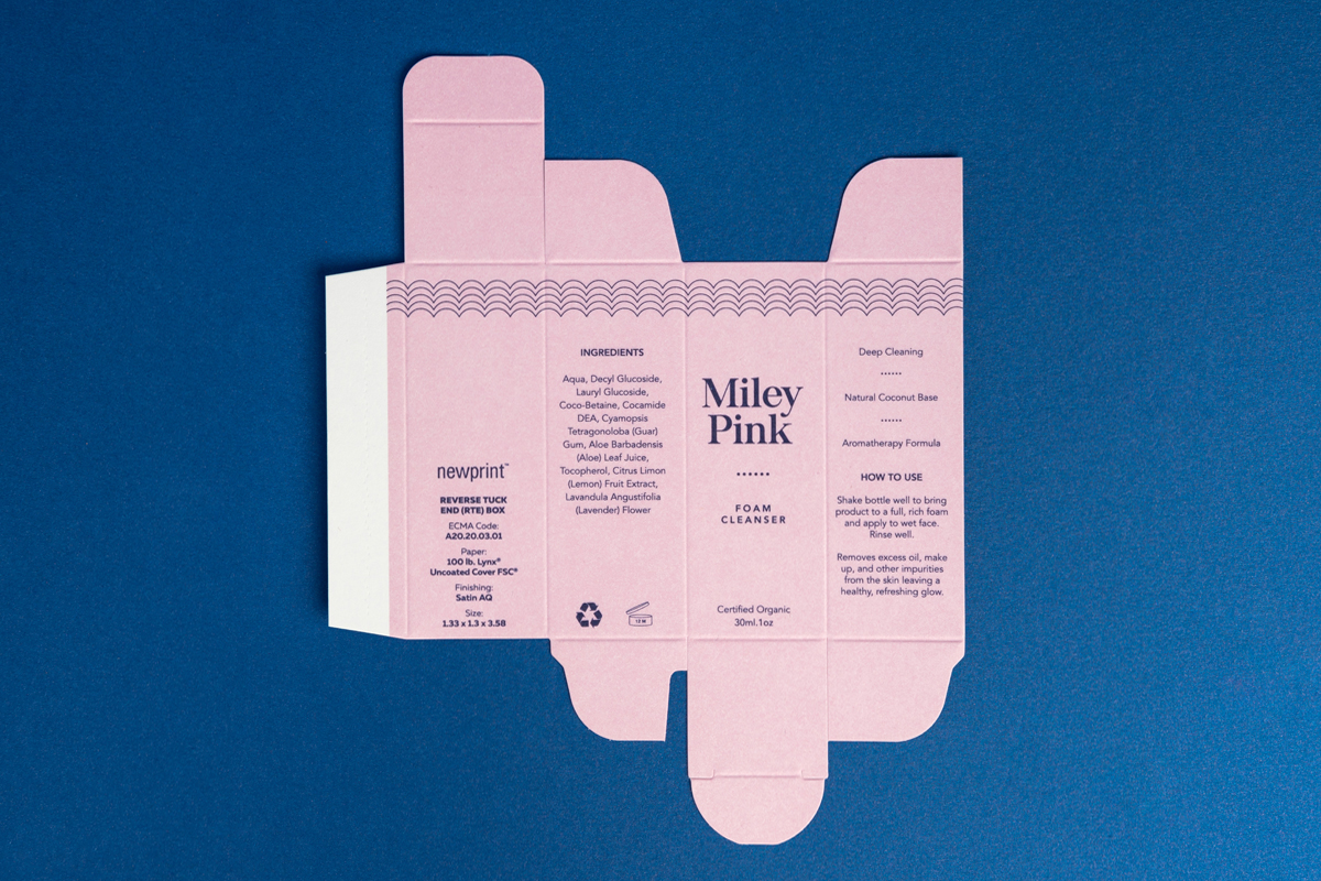 Image showing flat pink Reverse Tuck End box on dark blue background.